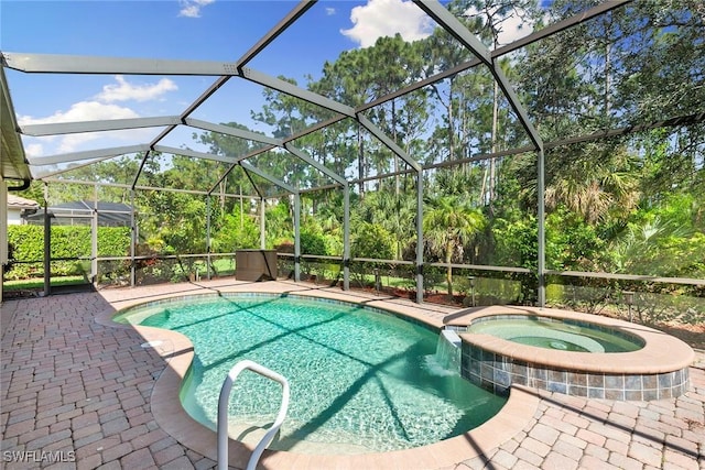 view of swimming pool featuring an in ground hot tub, glass enclosure, and a patio