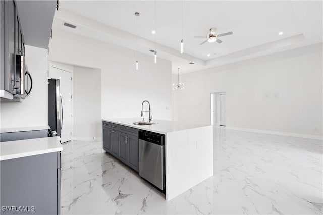 kitchen with visible vents, appliances with stainless steel finishes, decorative light fixtures, a tray ceiling, and light countertops