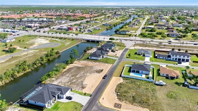 birds eye view of property featuring a water view and a residential view