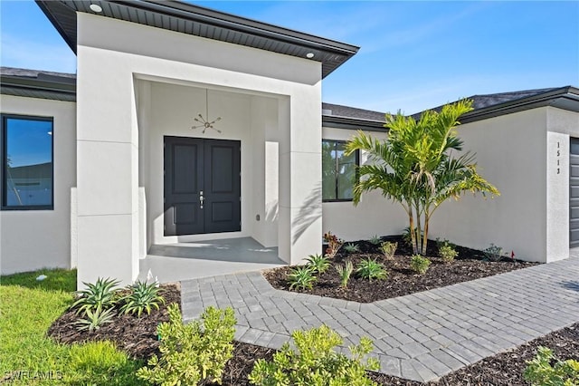 entrance to property featuring stucco siding