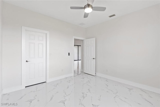 unfurnished bedroom with marble finish floor, a ceiling fan, visible vents, and baseboards