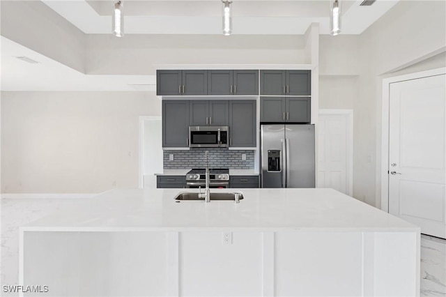 kitchen with stainless steel appliances, marble finish floor, light countertops, and gray cabinetry