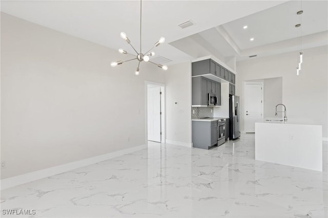 kitchen featuring a sink, light countertops, appliances with stainless steel finishes, and gray cabinets