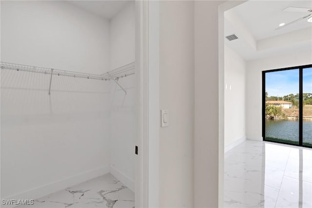 walk in closet featuring marble finish floor and visible vents