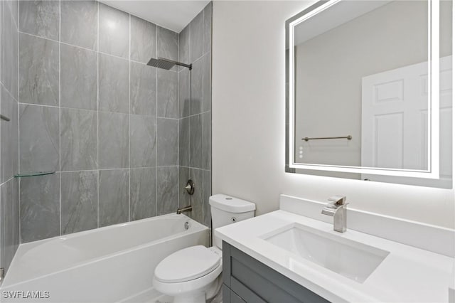 bathroom featuring toilet, bathing tub / shower combination, and vanity