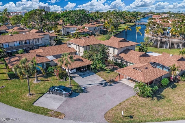 drone / aerial view featuring a water view and a residential view