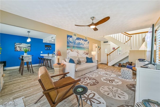 living room featuring hardwood / wood-style flooring and ceiling fan