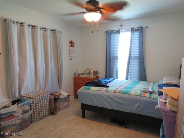 bedroom with ceiling fan and wood finished floors