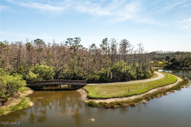 aerial view with a forest view and a water view