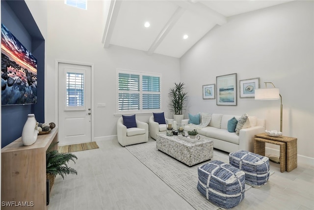 living room featuring high vaulted ceiling, light hardwood / wood-style flooring, and beam ceiling