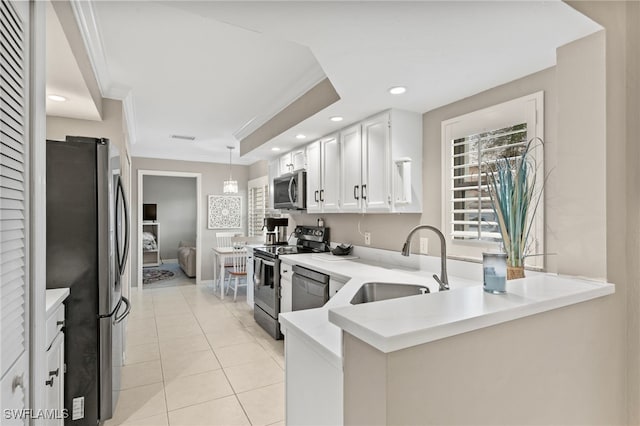 kitchen featuring stainless steel appliances, light countertops, a sink, and white cabinetry