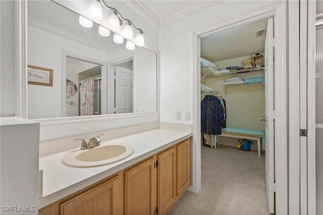 full bathroom with a closet, visible vents, ornamental molding, vanity, and tile patterned floors