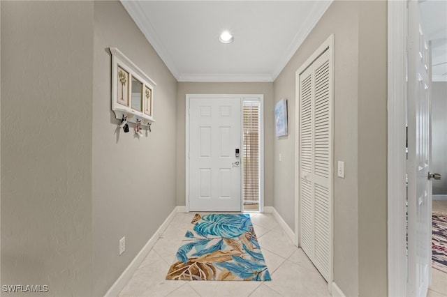 entryway featuring ornamental molding, baseboards, and light tile patterned floors