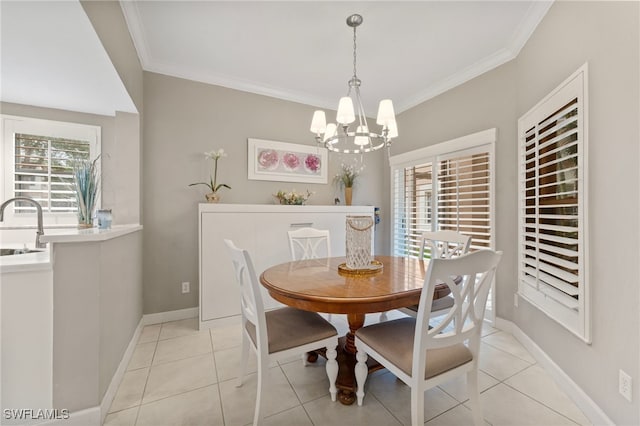 dining space with baseboards, light tile patterned floors, a chandelier, and crown molding