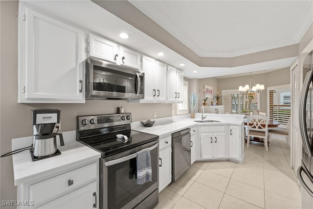 kitchen with stainless steel appliances, light countertops, and white cabinetry