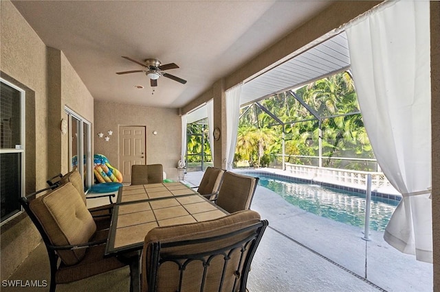 view of patio / terrace featuring ceiling fan and a lanai