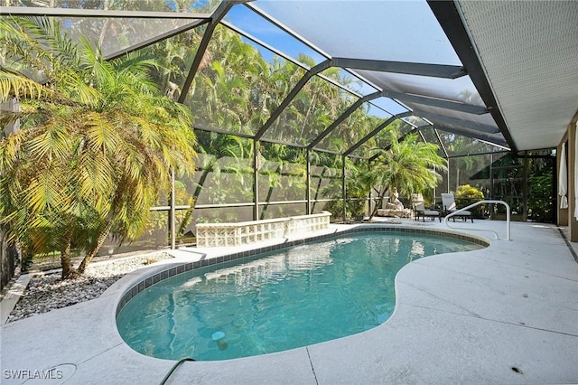 view of swimming pool featuring pool water feature, glass enclosure, and a patio area