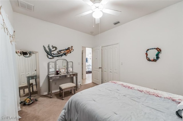 carpeted bedroom with a closet and ceiling fan