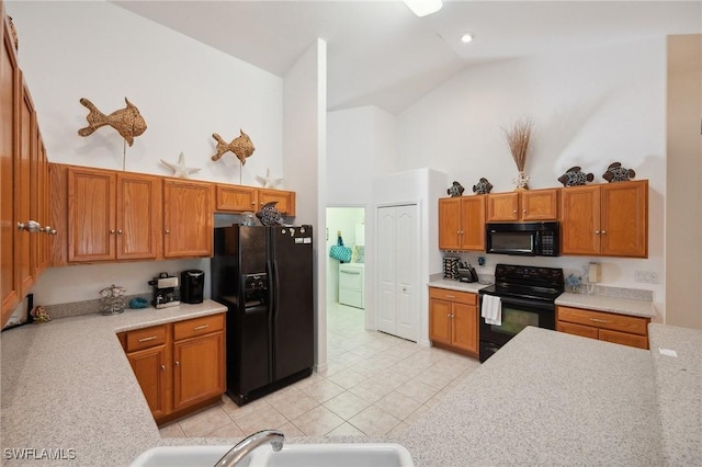 kitchen featuring high vaulted ceiling, sink, black appliances, and light tile patterned floors