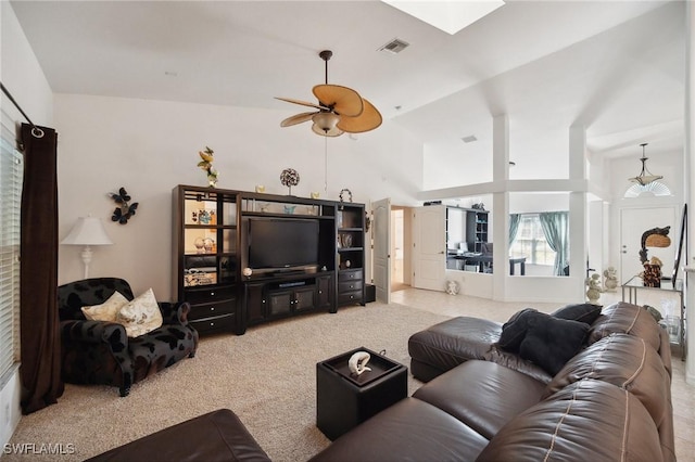 living room featuring ceiling fan, high vaulted ceiling, and light colored carpet