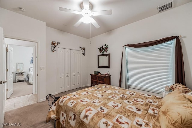 carpeted bedroom featuring a closet and ceiling fan