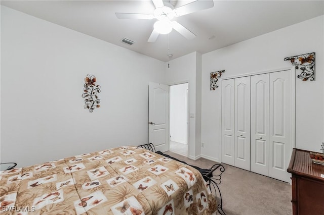 bedroom with ceiling fan, a closet, and light colored carpet