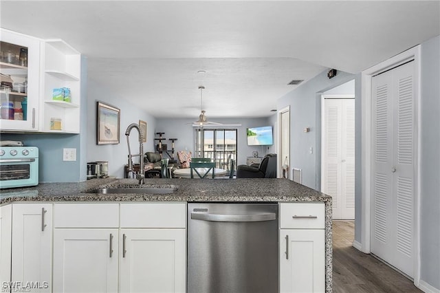 kitchen featuring sink, dishwasher, dark stone counters, dark hardwood / wood-style flooring, and white cabinets