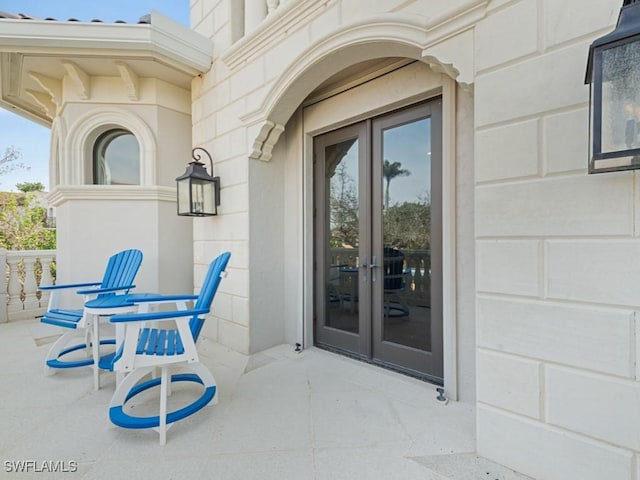 property entrance with a patio and french doors