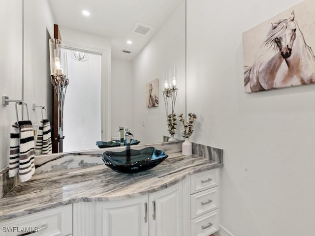 bathroom featuring recessed lighting, visible vents, baseboards, and vanity