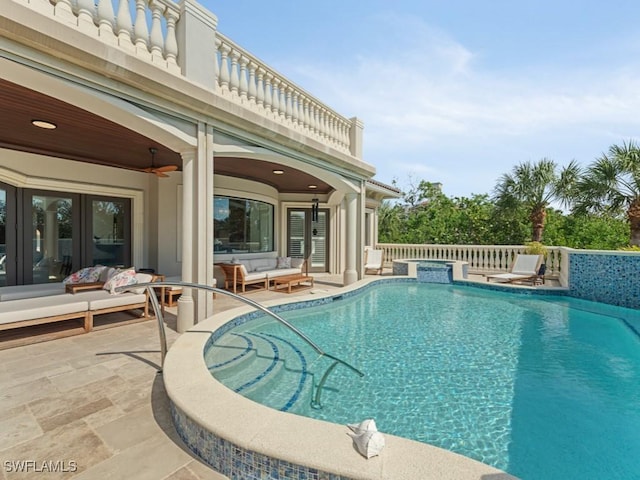 view of swimming pool with a patio, outdoor lounge area, and a pool with connected hot tub