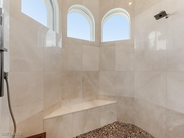 bathroom with tiled shower