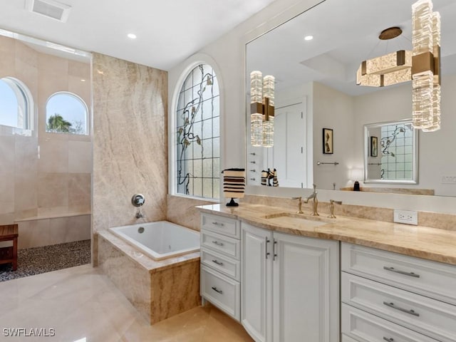 bathroom with vanity, a bath, a walk in shower, and recessed lighting