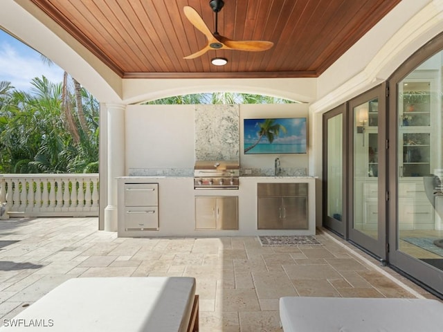 view of patio / terrace with ceiling fan, area for grilling, and an outdoor kitchen