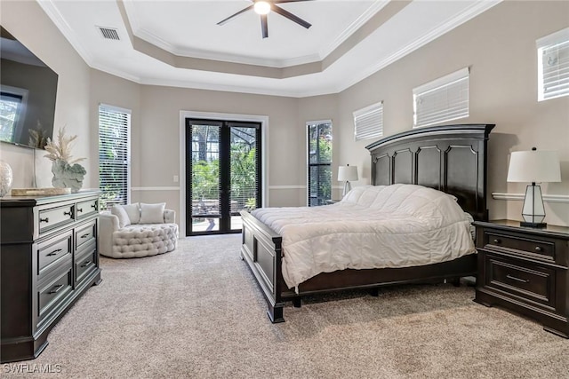 carpeted bedroom with access to outside, french doors, ceiling fan, a raised ceiling, and crown molding