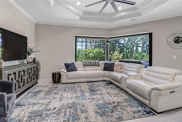 living room featuring crown molding, ceiling fan, and a raised ceiling