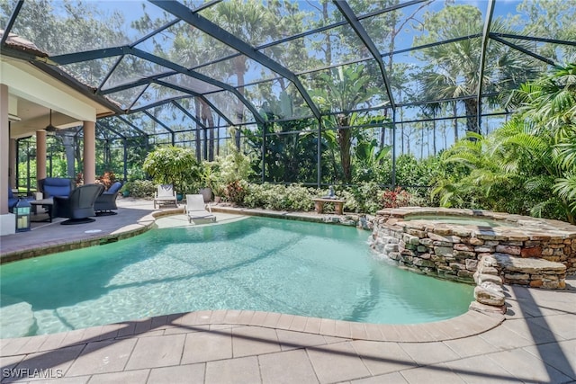 view of pool featuring a patio, an in ground hot tub, and a lanai