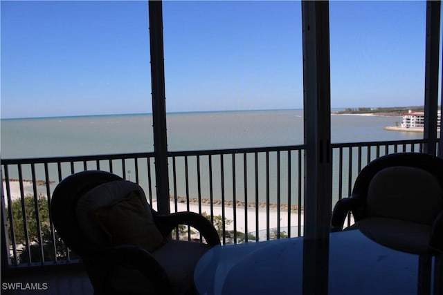 balcony with a view of the beach and a water view