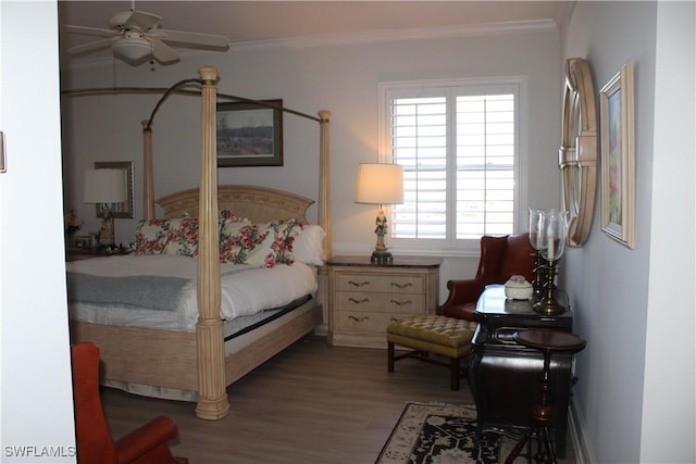 bedroom featuring ornamental molding and wood finished floors