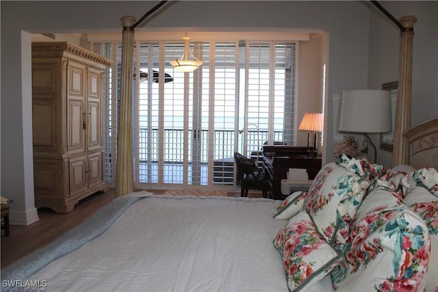 bedroom featuring access to outside and wood finished floors