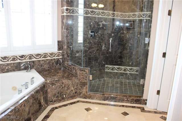 full bathroom featuring a whirlpool tub and a shower stall