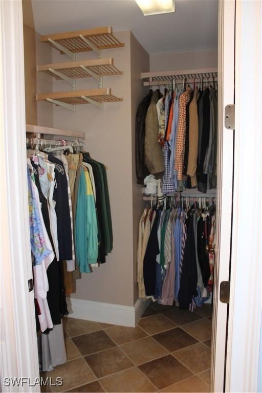 walk in closet with tile patterned flooring