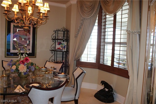 dining room with an inviting chandelier, baseboards, and ornamental molding