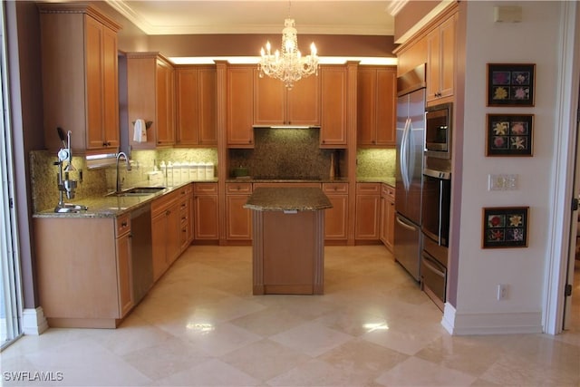 kitchen featuring light stone counters, ornamental molding, built in appliances, a center island, and a sink