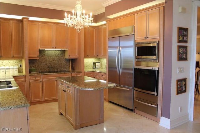 kitchen featuring a kitchen island, built in appliances, hanging light fixtures, crown molding, and a warming drawer