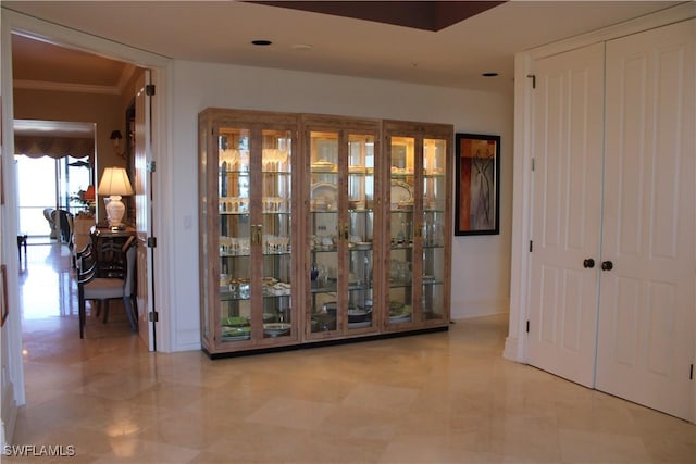 corridor featuring ornamental molding and baseboards