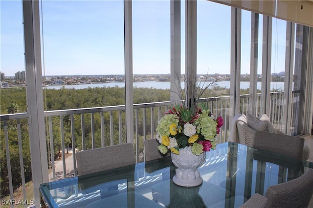 unfurnished sunroom featuring a water view