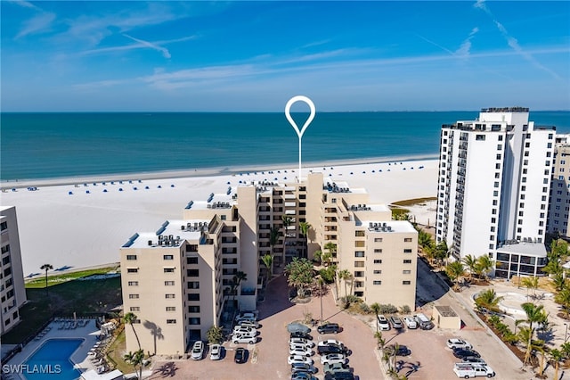 drone / aerial view featuring a water view and a view of the beach