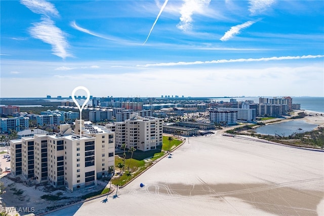 birds eye view of property with a water view and a city view