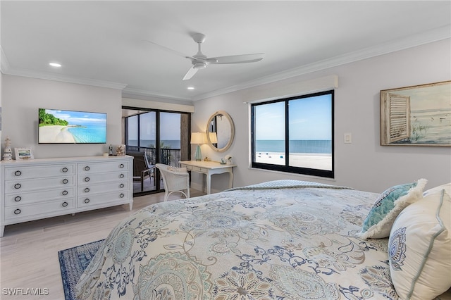 bedroom with a water view, light wood-style flooring, and crown molding