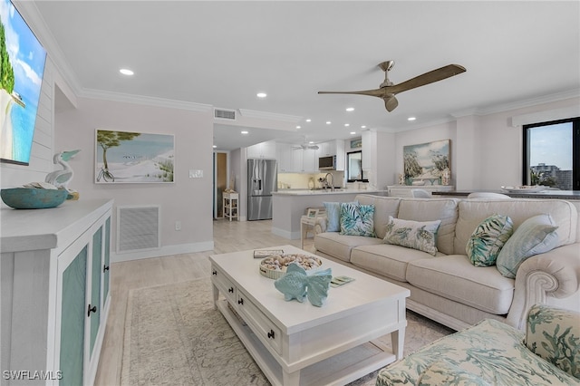 living area featuring ornamental molding, recessed lighting, visible vents, and ceiling fan